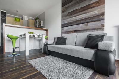 Reclaimed wood boards in apartment interior behind sofa