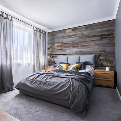 Grey bed with grey wall panels 