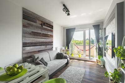 Reclaimed wood boards in apartment interior behind sofa