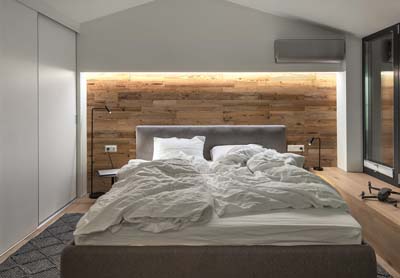 Boards in bedroom interior behind bed 