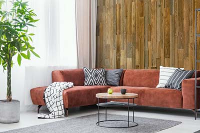 Reclaimed wood behind red couch 